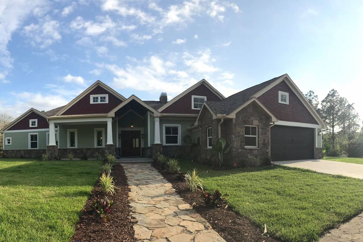 Craftsman-style custom home with a stone pathway, built by Beach Star Construction